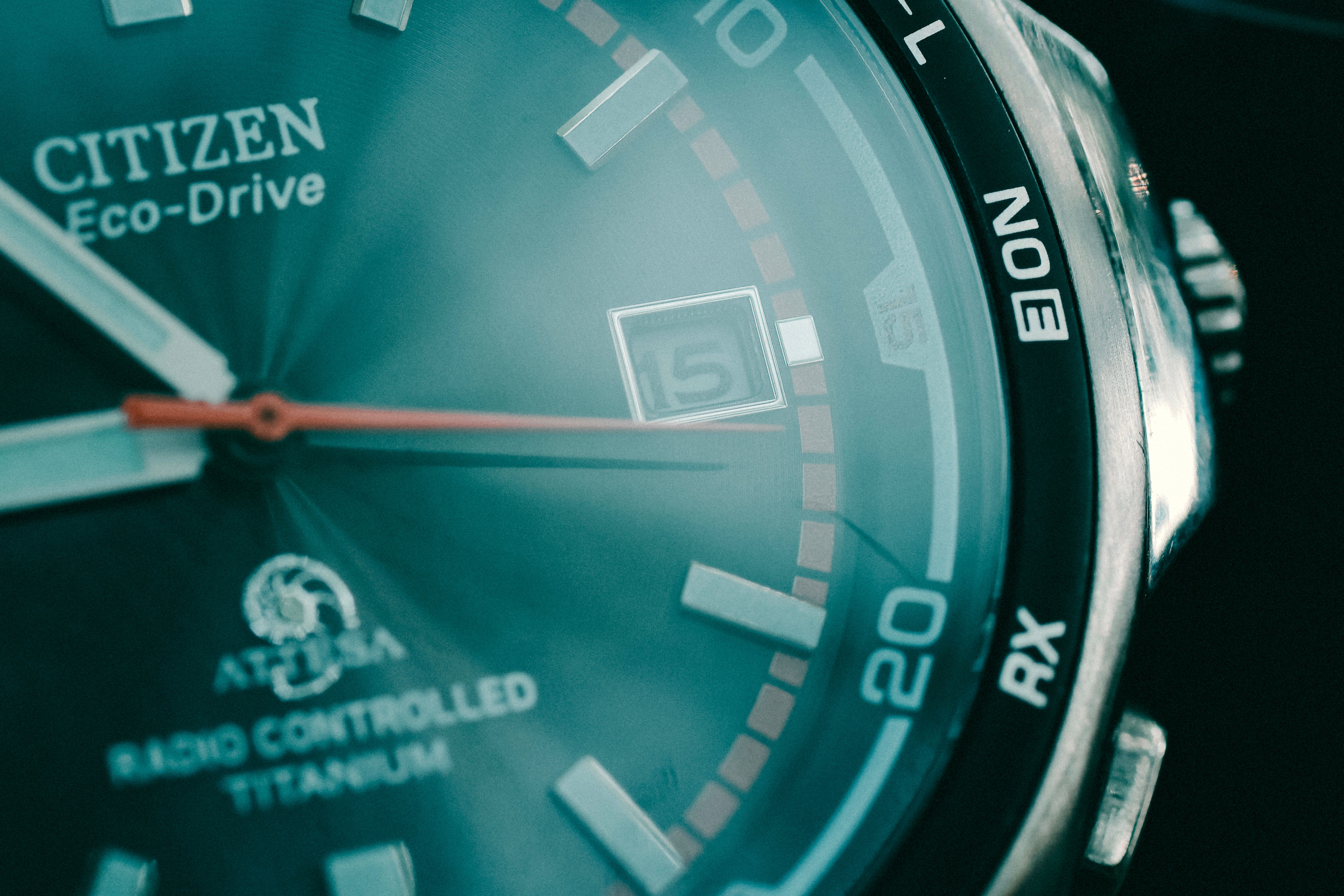 Citizen watch case and bracelet detail, close-up editorial shot on dark surface